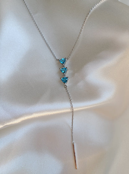 Falling necklace with three vivid blue trilliant topaz and natural diamonds 